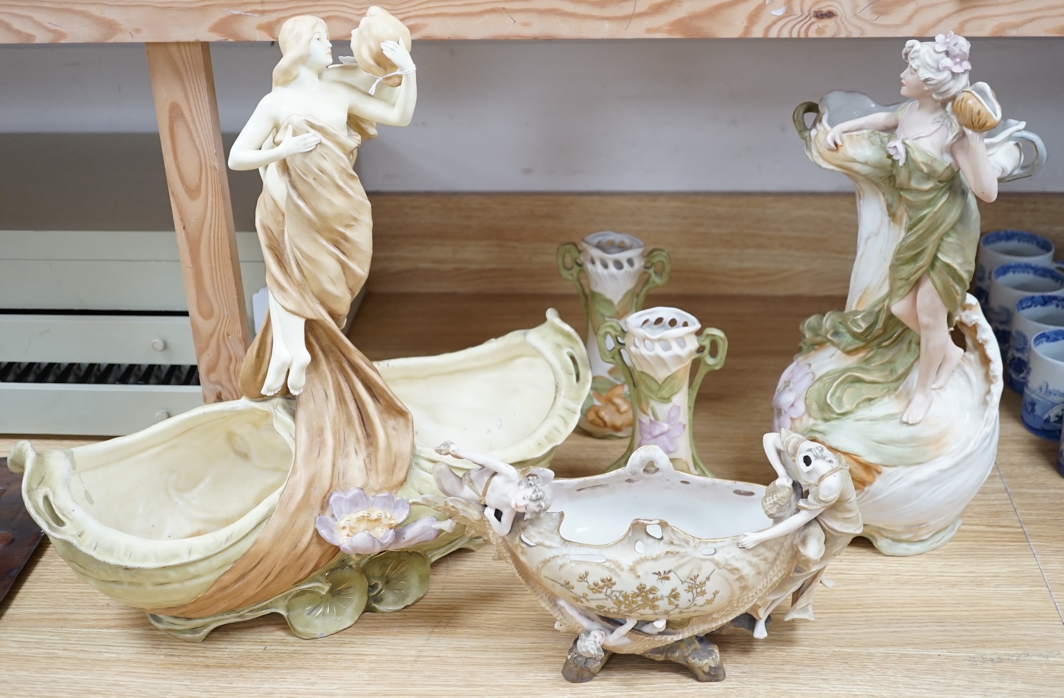 Five Royal Dux vases, including a pair of spill vases and a German porcelain boat shaped vase, largest 48cm high. Condition - four good, boat shaped vase poor